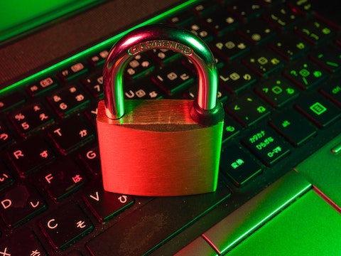 a padlock sitting on top of a laptop keyboard.