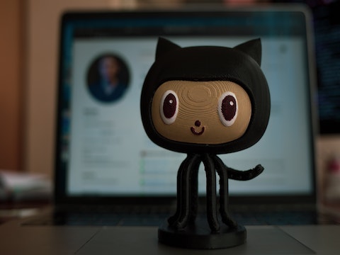 a minature toy statue of the GitHub logo 'Octocat'.